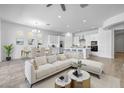 Stylish living and dining area with modern furniture, open to a kitchen with white cabinets and stainless appliances at 4314 E Bernice St, Gilbert, AZ 85295