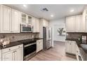 Updated kitchen featuring stainless steel appliances, custom cabinets, and plenty of counter space at 48 S Catalina St, Gilbert, AZ 85233