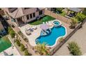 Aerial view of a backyard featuring a pool, spa, lounge area, and outdoor kitchen at 5051 S Moccasin Trl, Gilbert, AZ 85298