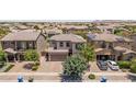 Aerial view of a well-landscaped two-story home with a brick-paved driveway and a two-car garage at 5051 S Moccasin Trl, Gilbert, AZ 85298