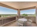 Relaxing outdoor balcony with scenic views, complete with a table and chairs at 6010 E Languid Ln, Carefree, AZ 85377