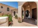 Charming front porch with arched entry and well-kept desert landscaping at 6010 E Languid Ln, Carefree, AZ 85377