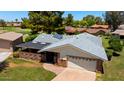 Aerial view of home featuring gray shingled roof, two-car garage, and a covered patio at 631 Leisure World --, Mesa, AZ 85206