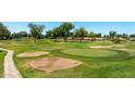 Scenic view of a well-maintained golf course featuring sand traps, manicured greens, and beautiful landscaping at 631 Leisure World --, Mesa, AZ 85206