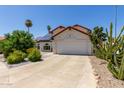 Charming single Gathering home with a two car garage, solar panels, and desert landscaping at 7108 W Morrow Dr, Glendale, AZ 85308