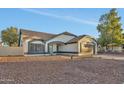 Charming single-story home featuring a two-car garage and desert landscaping in front at 7685 W San Miguel Ave, Glendale, AZ 85303