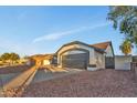 Charming single-story home featuring a two-car garage and desert landscaping in front at 7685 W San Miguel Ave, Glendale, AZ 85303