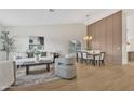 Bright living room with vaulted ceilings, wood-look floors, and elegant furniture at 7685 W San Miguel Ave, Glendale, AZ 85303