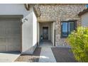 Close-up of front door featuring stone accents and a covered entryway at 8027 W Northview Ave, Glendale, AZ 85303