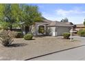 Single Gathering home with desert landscaping and 2 car garage, under a sunny sky at 8753 E Plata Ave, Mesa, AZ 85212