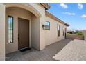 Inviting front entry with a covered porch and brick-paved walkway to the driveway at 8820 E Ivy Cir, Mesa, AZ 85207
