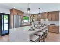 Beautiful kitchen featuring an island with seating and modern pendant lighting at 9450 N 83Rd Pl, Scottsdale, AZ 85258