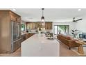 Open kitchen with large island, stainless steel appliances, and view to the living room at 9450 N 83Rd Pl, Scottsdale, AZ 85258
