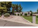 Lovely home featuring a circular driveway, desert landscaping, and green grass at 1010 E Buena Vista Dr, Tempe, AZ 85284