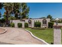 Well-maintained home featuring a circular driveway, desert landscaping, and manicured green grass at 1010 E Buena Vista Dr, Tempe, AZ 85284