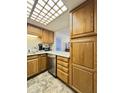 Well-equipped kitchen features wooden cabinetry and stainless steel appliances at 10330 W Thunderbird Blvd # C206, Sun City, AZ 85351