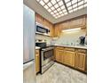 Charming kitchen with stainless steel appliances, wood cabinets and skylight at 10330 W Thunderbird Blvd # C206, Sun City, AZ 85351
