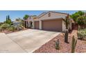 Inviting single-story home with desert landscaping and a convenient two-car garage at 10449 E Jacob Ave, Mesa, AZ 85209