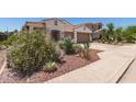 Attractive single-story home with desert landscaping elements and a two-car garage at 10449 E Jacob Ave, Mesa, AZ 85209