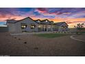 Gorgeous new construction farmhouse with a black roof during sunset at 11564 E Windsor Way, Florence, AZ 85132