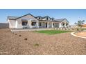 New construction farmhouse-style home with pristine white exterior and professional desert landscaping at 11564 E Windsor Way, Florence, AZ 85132