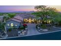 Beautiful home featuring mature landscaping and a paved driveway, creating a welcoming entrance at 11773 E Desert Trail Rd, Scottsdale, AZ 85259