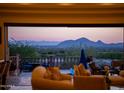 Covered patio showcasing comfortable seating and scenic mountain views at 11773 E Desert Trail Rd, Scottsdale, AZ 85259