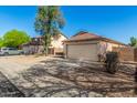 Spacious driveway and a well-manicured front yard leading to the attached two-car garage at 1447 E 12Th Pl, Casa Grande, AZ 85122