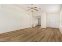 Bright living room with wood flooring and a ceiling fan for a comfortable living space at 1447 E 12Th Pl, Casa Grande, AZ 85122