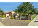 Attractive single-story home with desert landscaping and a low decorative wall at 14844 W Pershing St, Surprise, AZ 85379