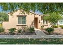 Charming single-story home with a well-manicured lawn and desert landscaping at 14844 W Pershing St, Surprise, AZ 85379
