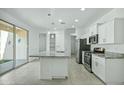 Stylish modern kitchen with stainless steel appliances and a large island at 14844 W Pershing St, Surprise, AZ 85379