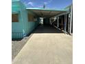Extended carport and covered patio on the side of a turquoise mobile home at 150 S Windsor Dr # 35, Mesa, AZ 85204