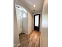 Inviting entryway with wood-look tile flooring, neutral walls, and decorative front door with glass inserts at 2715 E Canyon Creek Dr, Gilbert, AZ 85295