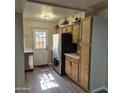 Bright kitchen with stainless steel appliances, wood cabinets, and a back door at 2946 N 14Th N St # 14, Phoenix, AZ 85014
