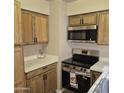 An efficient kitchen featuring stainless steel appliances and warm, wood cabinetry at 2946 N 14Th N St # 14, Phoenix, AZ 85014