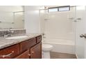 Bathroom with wood cabinets and a shower over tub combination at 31515 W Buchanan St, Buckeye, AZ 85326