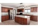 Kitchen featuring stainless steel appliances, dark wood cabinets, and center island at 31515 W Buchanan St, Buckeye, AZ 85326