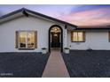 Charming single-story home with a welcoming front porch, manicured landscape, and a well-lit entrance at 3506 W Yucca St, Phoenix, AZ 85029
