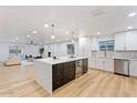 Modern kitchen featuring a large island, stainless steel appliances, and sleek white cabinets at 3506 W Yucca St, Phoenix, AZ 85029