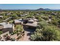 Expansive aerial view of the desert home, landscape, neighborhood and surrounding mountains at 41576 N 107Th Way, Scottsdale, AZ 85262