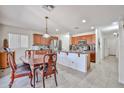 Bright kitchen with wood cabinets, stainless steel appliances, and an adjacent dining area at 4318 W Apollo Rd, Laveen, AZ 85339