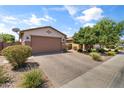 Single-story home with desert landscaping, brick driveway, and a two-car garage at 455 W Evergreen Pear Ave, Queen Creek, AZ 85140