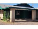 A covered parking area with brick pillars and a view of the house behind at 5016 W Sunrise Dr, Laveen, AZ 85339