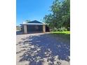 Charming property featuring a covered parking area with a tree for shade on a sunny day at 5016 W Sunrise Dr, Laveen, AZ 85339