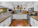 Bright kitchen featuring white cabinetry, granite countertops, and stainless steel appliances at 5930 E Fountain St, Mesa, AZ 85205