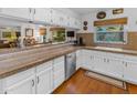 Bright kitchen featuring white cabinetry, granite countertops, and stainless steel appliances at 5930 E Fountain St, Mesa, AZ 85205