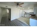Bright kitchen with white cabinets and updated appliances, adjacent to flexible living space at 6565 N 19Th Ave # 38, Phoenix, AZ 85015