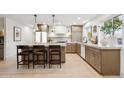 Bright kitchen featuring a large island with seating, modern appliances, and stylish cabinets at 7432 E Holly St, Scottsdale, AZ 85257