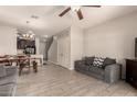 Open concept living space with tile floors, dining area, and comfortable gray couches at 7726 E Baseline Rd # 154, Mesa, AZ 85209